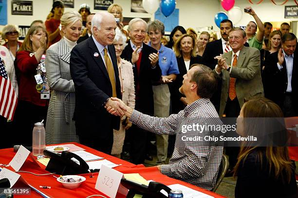 Republican presidential nominee Sen. John McCain shakes hands with volunteers and thanks them for their time and work at a campaign call center...