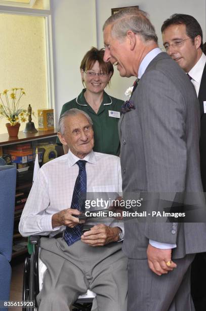 The Prince Of Wales and nurse Annette Morgan chats with Alfred 'Harry' Moor from Llandovery, who served in the Royal Horse Guards and was at Prince...