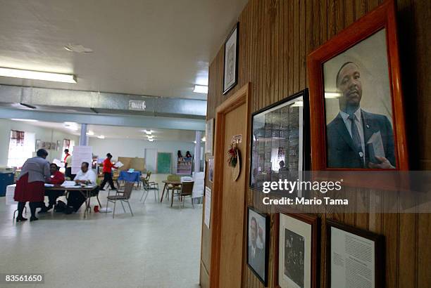 African-Americans are seen in a polling place behind a portrait of Dr. Martin Luther King Jr. November 4, 2008 in Selma, Alabama. Selma was a...