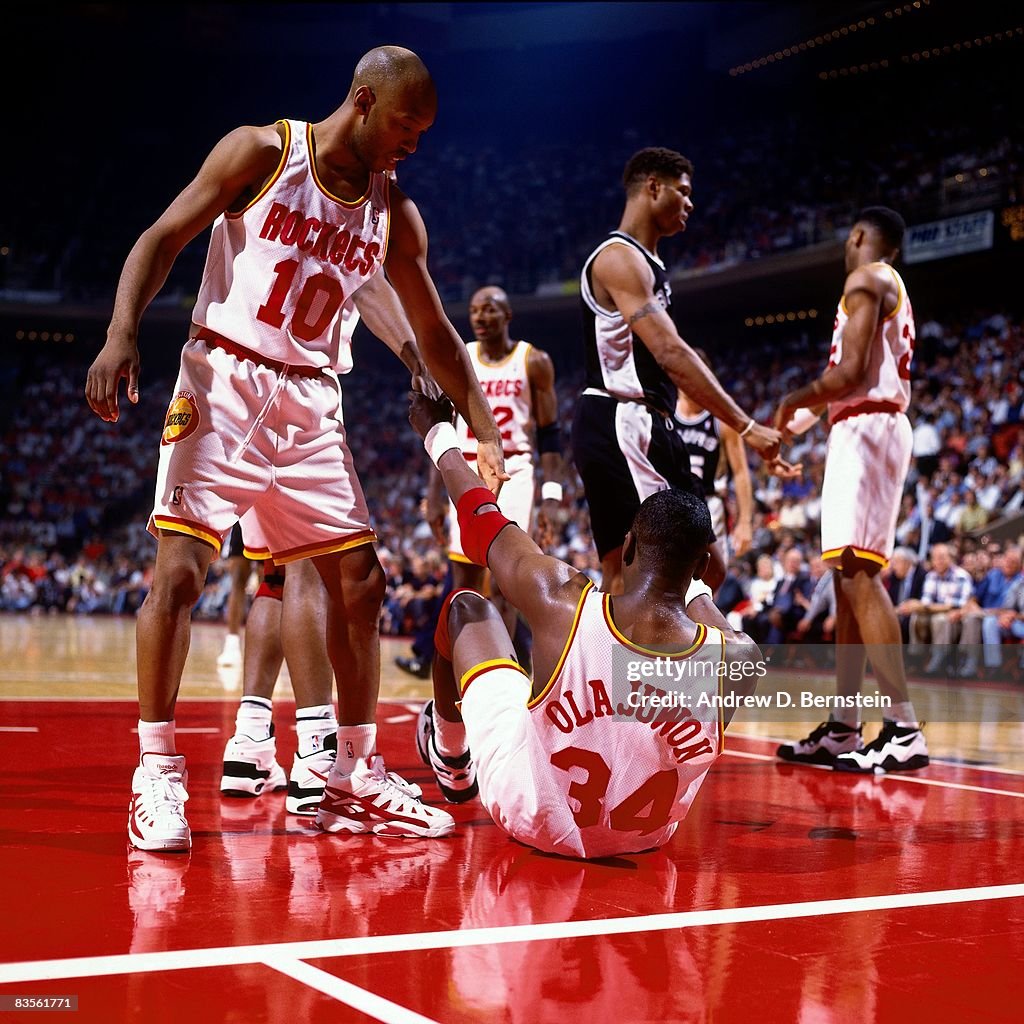 1995 Rockets Final Sam Cassell of the Houston Rockets helps teammate Hakeem Olajuwon off ...