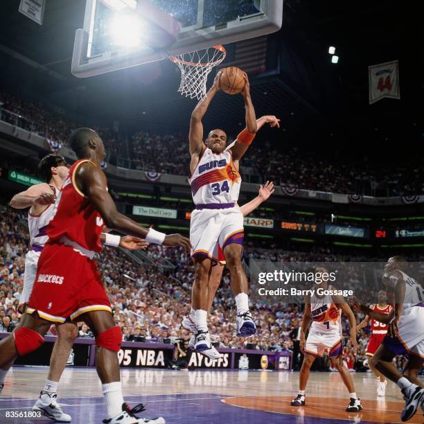 Charles Barkley of the Phoenix Suns grabs the rebound in Game Seven of the 1995 NBA Western Conference semifinals against the Houston Rockets on May...