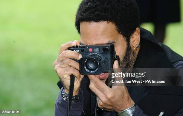 Lenny Kravitz, who is celebrating 20 years in the music industry, takes photos during a photocall to launch his new Let Love Rule tour, at the...