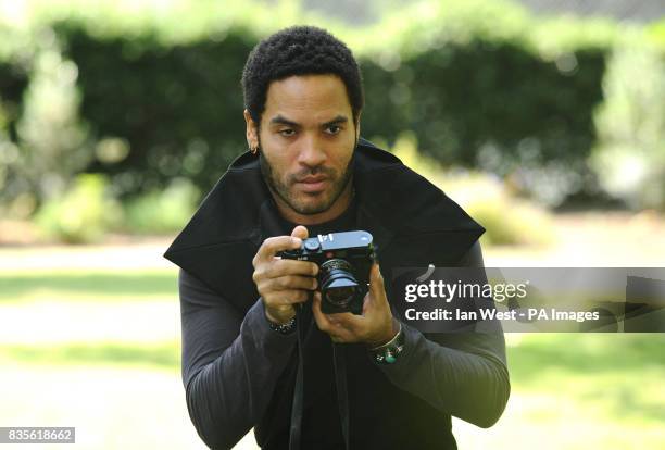 Lenny Kravitz, who is celebrating 20 years in the music industry, takes photos during a photocall to launch his new Let Love Rule tour, at the...