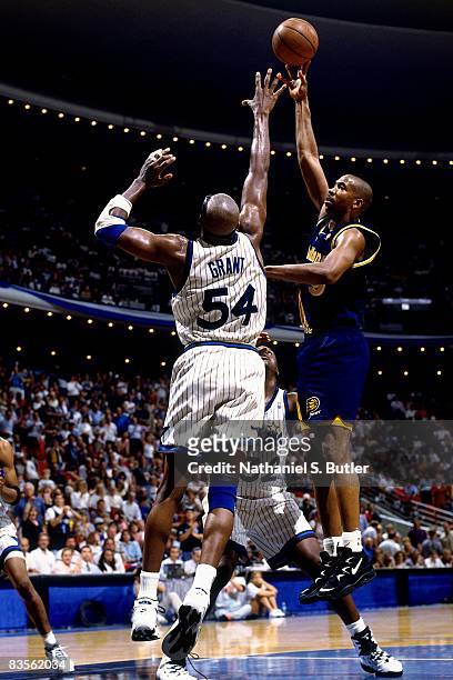 Derrick McKey of the Indiana Pacers shoots over Horace Grant of the Orlando Magic in Game One of the 1995 NBA Eastern Conference Finals at the...
