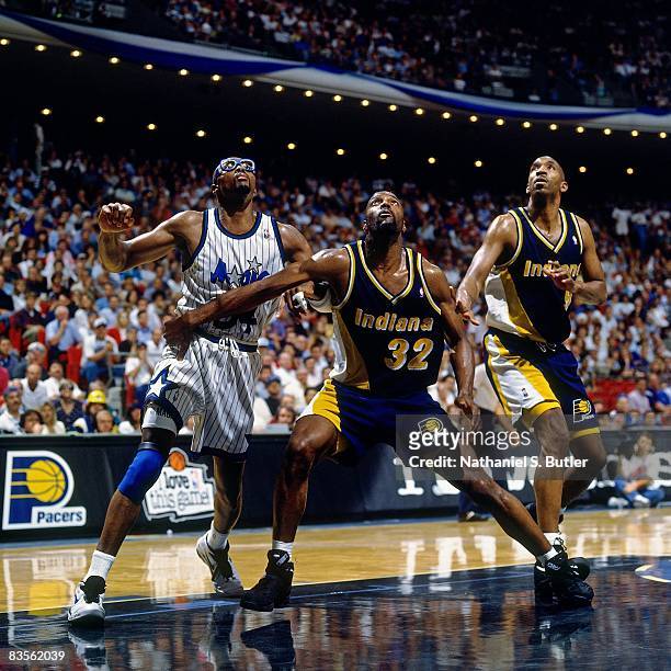 Dale Davis of the Indiana Pacers boxes out against Horace Grant of the Orlando Magic in Game One of the 1995 NBA Eastern Conference Finals at the...
