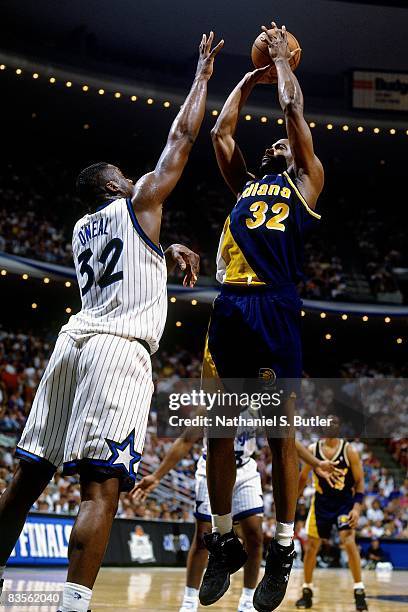 Dale Davis of the Indiana Pacers goes up for a shot against Shaquille O'Neal of the Orlando Magic in Game One of the 1995 NBA Eastern Conference...