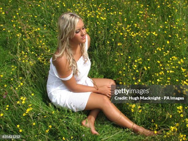 Shannon Waring relaxes in a rare ancient hay meadow now in full bloom at Barrowburn Farm in the Upper Coquet Valley part of the Cheviot Hills in...