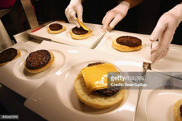 Waitstaff prepare hamburgers at a U.S.election party at the Bertelsmann representation on November 4, 2008 in Berlin, Germany. German media have been...