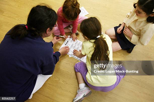 With a little help from her three daughters - 3 and 7 years old , Jill Gerber fills out her ballot at a polling station on November 4, 2008 in...