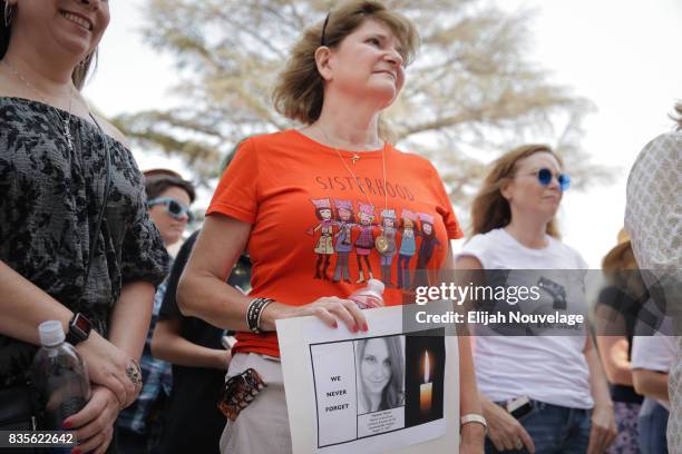 Donna Bisio, center, of San Jose, holds a sign remembering Heather Heyer, who was killed last week in Charlottesville, Va., at a rally against white...