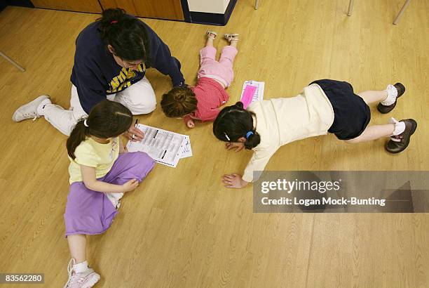 Jill Gerber fills out her ballot with her three daughters at a polling station on November 4, 2008 in Wrightsville Beach, North Carolina. After...