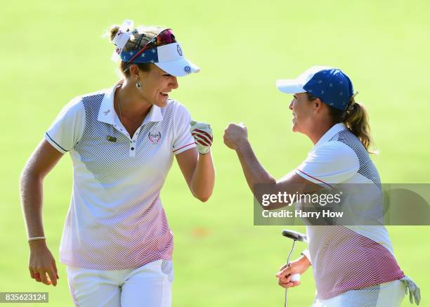 Cristie Kerr of Team USA celebrates her birdie putt with Lexi Thompson to halve the 12th hole with Team Europe during the evening four-ball matches...