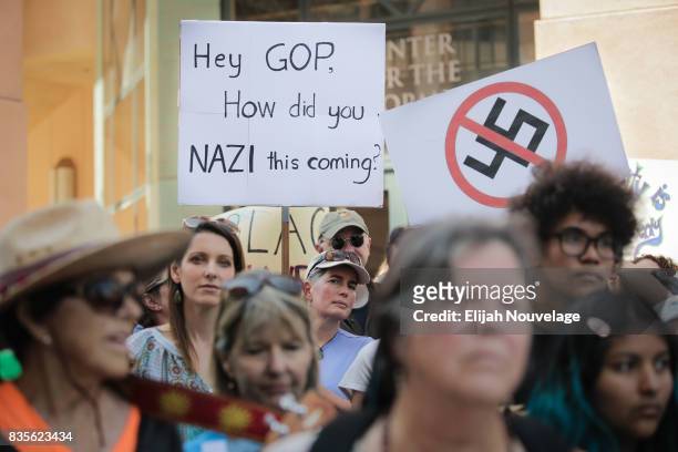 Attendees hold signs protesting Pres. Donald Trump and the GOP at a rally against white nationalism on August 19, 2017 in Mountain View, California....