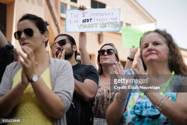 Woman holds up a sign regarding the First Amendment at a rally against white nationalism on August 19, 2017 in Mountain View, California. Just one...