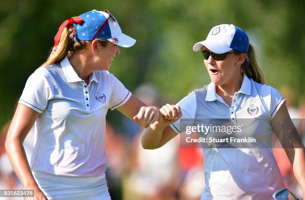 Austin Ernst of Team USA celebrates chipping in on the 15th hole with Paula Creamer during the second day afternoon fourball matches of The Solheim...