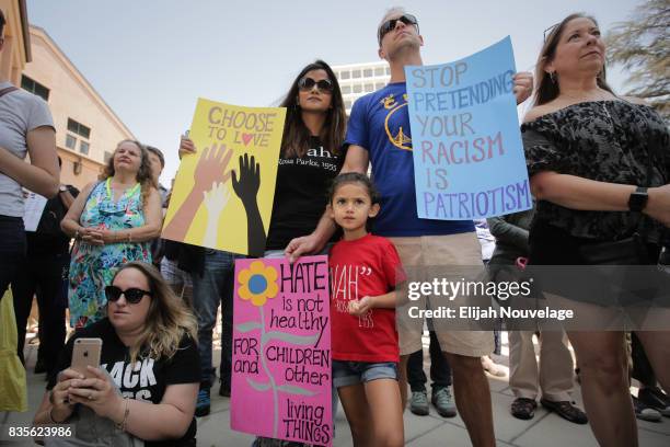 Shana and Luke Farley and their daughter Ariel of Mountain View, attend a rally against white nationalism on August 19, 2017 in Mountain View,...