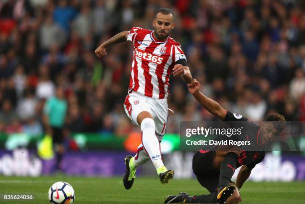 Jese of Stoke City is challenged by Alex Oxlade-Chamberlain during the Premier League match between Stoke City and Arsenal at Bet365 Stadium on...