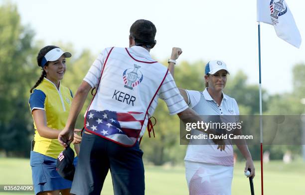 Cristie Kerr of the United States Team celebrates with Lexi Thompson on the 16th green after their win against Catriona Matthew and Georgia Hall of...