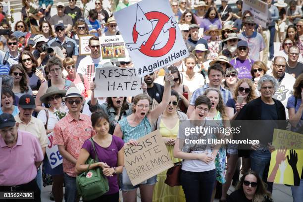 People cheer and hold signs at a rally against white nationalism on August 19, 2017 in Mountain View, California. Just one week after the violent...