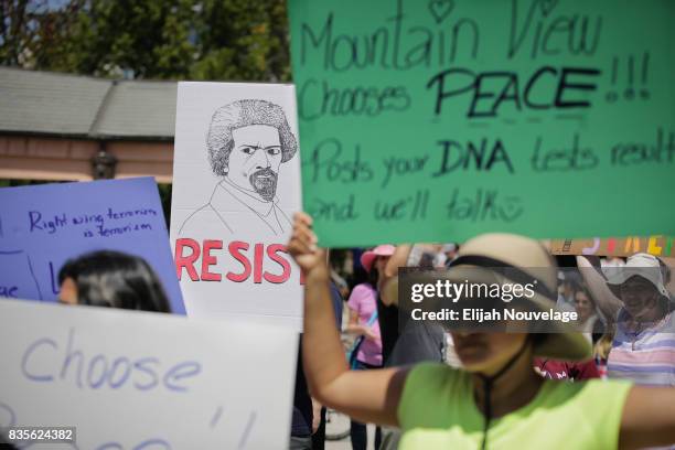 People hold signs of resistance at a rally against white nationalism on August 19, 2017 in Mountain View, California. Just one week after the violent...