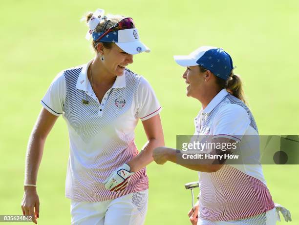 Cristie Kerr of Team USA celebrates her birdie putt with Lexi Thompson to halve the 12th hole with Team Europe during the evening four-ball matches...