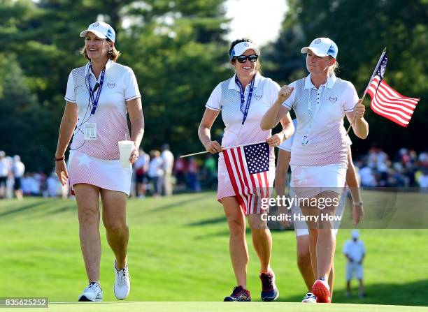 Stacy Lewis, Gerina Piller and Juli Inkster of Team USA celebrate a two and one win over Team Europe in the final match of the day during the evening...