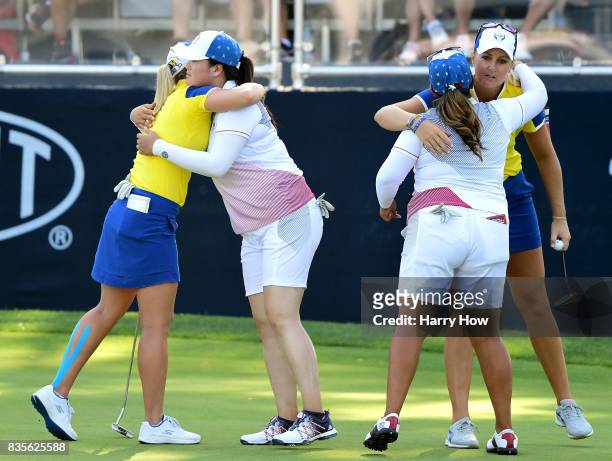 Anna Nordqvist of Team Europe receives a hug from Lizette Salas of Team USA, while Angel Yin of Team USA hugs Jodi Ewart Shadoff of Team Europe,...