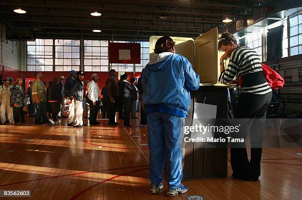 African-Americans line up to vote in a school gymnasium in the presidential election November 4, 2008 in Birmingham, Alabama. Birmingham, along with...