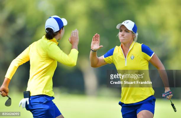 Mel Reid of Team Europe celebrates with Carlota Ciganda during the second day afternoon fourball matches of The Solheim Cup at Des Moines Golf and...