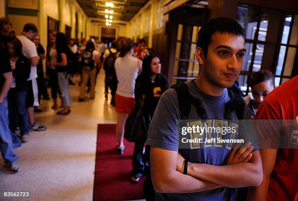 Aalab Kothari a freshman at The University of Pittsburgh, stands in line with other voters waiting to cast a ballot during evening voting at a...