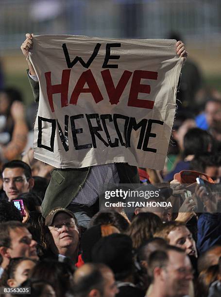 Supporter of Democratic presidential candidate Barack Obama hoists a banner as crowds arrive at Grant Park on election day, November 4, 2008 in...