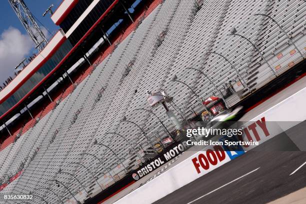 Cars drive past the Bristol Motor Speedway logo painted on the front stretch during practice for the Food City 300 on August 17 at the Bristol Motor...