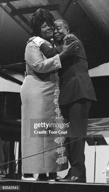 Jazz trumpeter Louis Armstrong performs with Gospel singer Mahalia Jackson at the Newport Jazz Festival On July 10, 1970 at Festival Field in...