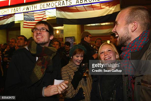 People react to exit polls in U.S. Elections shown on an outdoor projector outside the already full-to-capacity Babylon theatre where a U.S. Election...