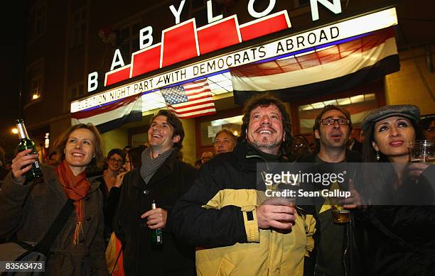 People react to exit polls in U.S. Elections shown on an outdoor projector outside the already full-to-capacity Babylon theatre where a U.S. Election...