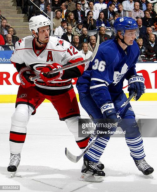 Eric Staal of the Carolina Hurricanes battles for position with Anton Stralman of the Toronto Maple Leafs during their NHL game at the Air Canada...