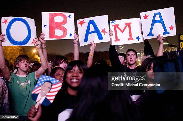 Supporters of Democratic US presidential nominee Sen. Barack Obama hold up signs in the non-ticket holder area of Grant Park where later tonight Sen....