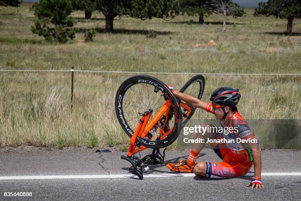 Yuma Koishi of the Nippo-Vini Fantini team sits on the ground after a crash during stage 3 of the Colorado Challenge on August 12, 2017 in Denver,...