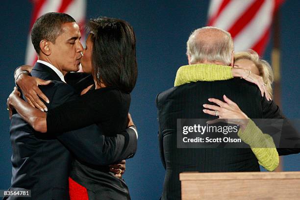 President elect Barack Obama kisses his wife Michelle as Vice-President elect Joe Biden embraces his wife Jill after Obama gave his victory speech...