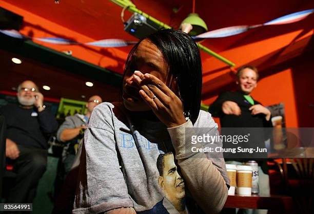 Member of Democrats Abroad Korea weep after Barack Obama swept to victory as the nation's first black President at the Orange tree on November 5,...
