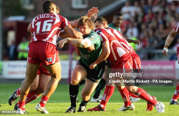 St Helens Paul Clough is tackled by Salford's Phil Leuluai during a Super League match at The Willows, Salford.