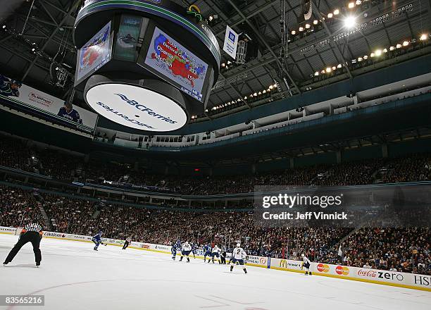 Fans a General Motors Place cheer as the results of the United States Presidential election are flashed on the scoreclock during the NHL game between...