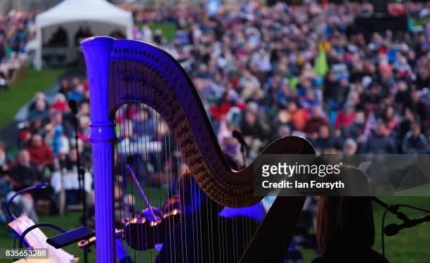 Musician with the London Gala Orchestra plays the harp as thousands of spectators attend the annual Castle Howard Proms Spectacular concert held on...