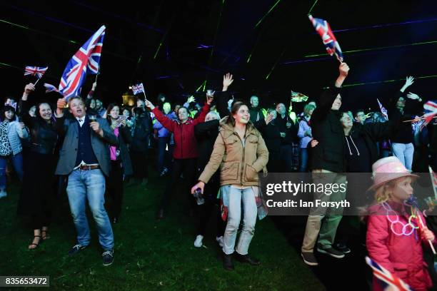 Thousands of spectators react to the music as they attend the annual Castle Howard Proms Spectacular concert held on the grounds of the Castle Howard...