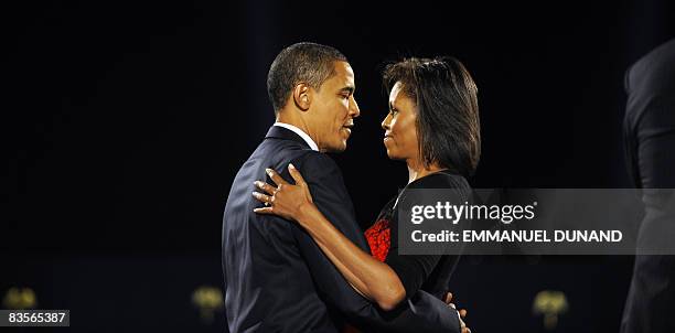 President-elect Barack Obama and his wife Michelle embrace on stage during Obama's election night victory rally at Grant Park on November 4, 2008 in...