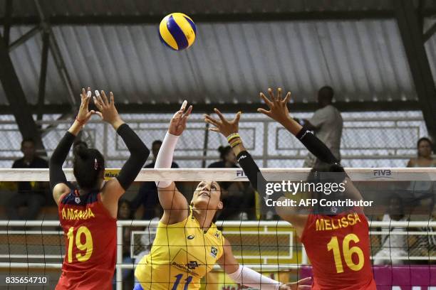 Colombian players Amanda Coneo and Melissa Rangel try to block the smash by Brazilian Tandara Caixeta during the Women's South American Volleyball...