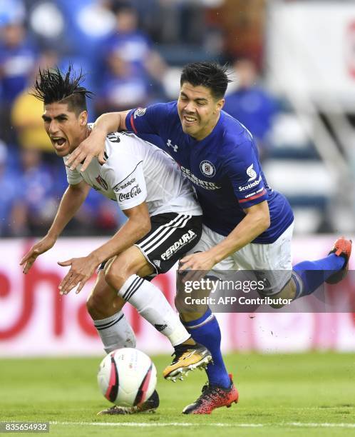 Atlas defender Jose Maduena vies for the ball with Cruz Azul defender Francisco Silva during their Mexican Apertura tournament football match at the...