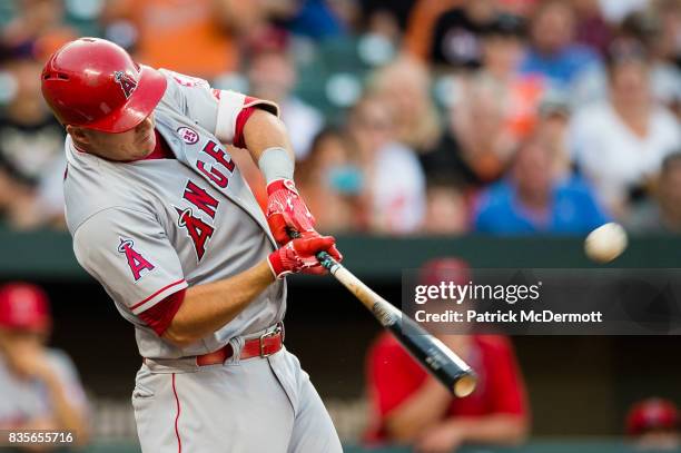 Mike Trout of the Los Angeles Angels of Anaheim hits a solo home run in the first inning during a game against the Baltimore Orioles at Oriole Park...