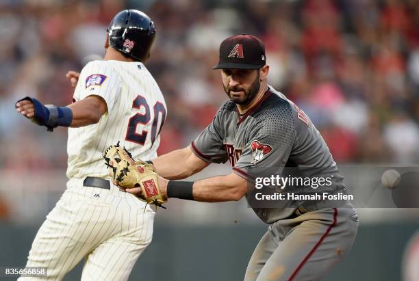 Eddie Rosario of the Minnesota Twins runs safely to second base as Daniel Descalso of the Arizona Diamondbacks is unable to field the ball during the...