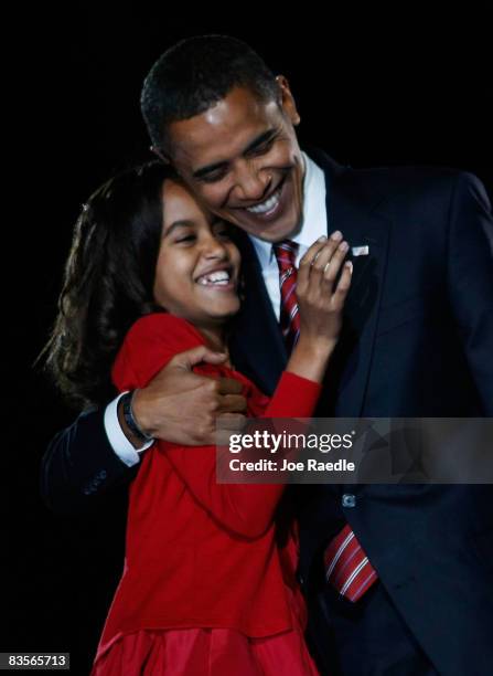 President elect Barack Obama embraces his daughter Malia after Obama gave his victory speech during an election night gathering in Grant Park on...